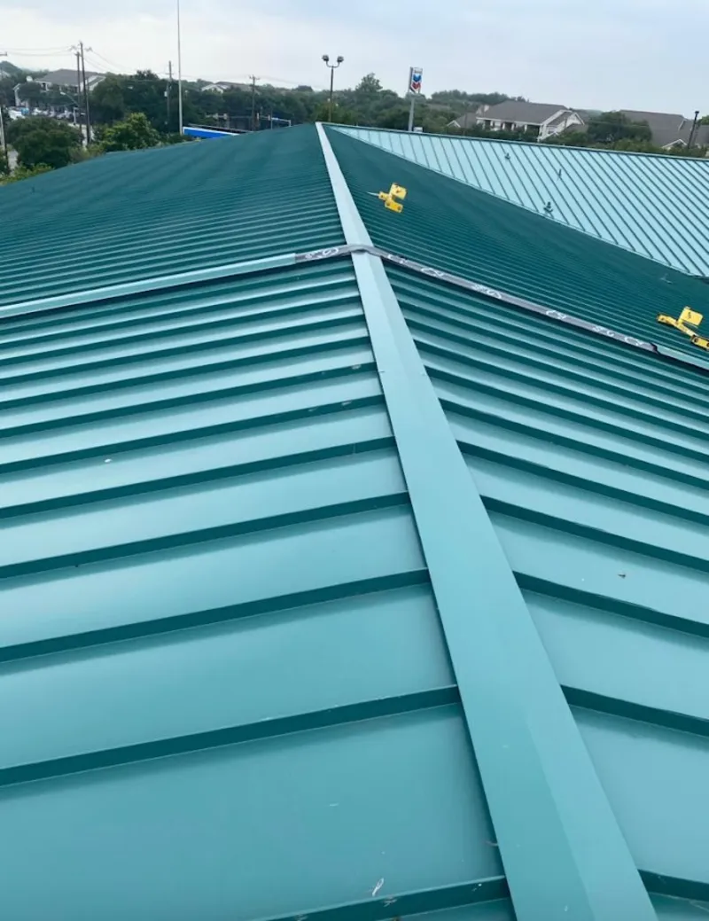 Green commercial metal roof ridge and valley for Metal Roof Repair in Eau Claire