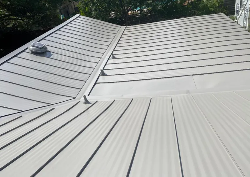 Solar attic fan installed on a metal roof for Roof Ventilation in Eau Claire